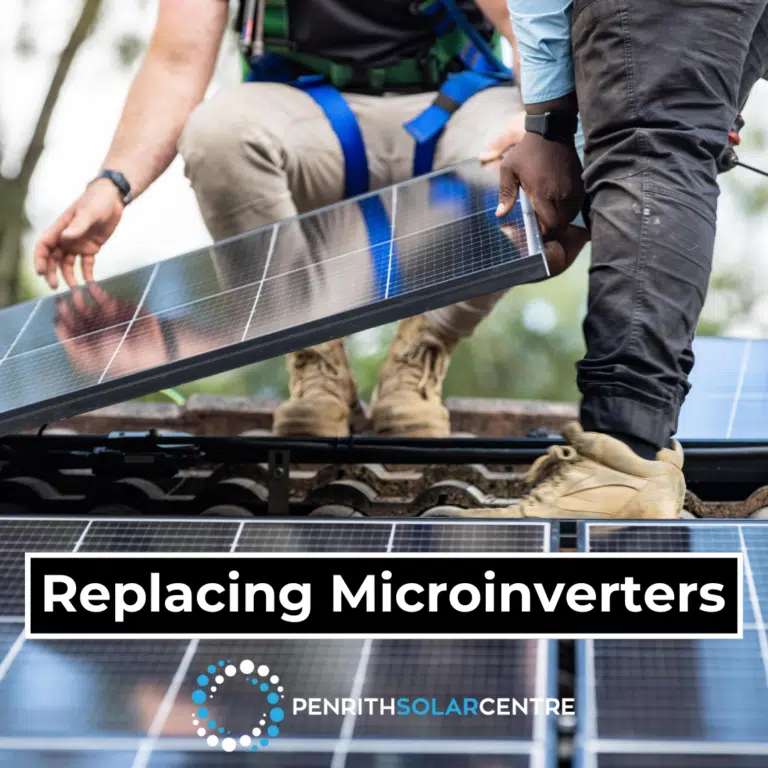 Two technicians are replacing microinverters on a solar panel array. Text on the image reads, "Replacing Microinverters" and "Penrith Solar Centre.