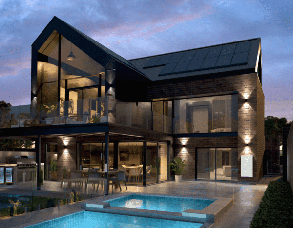 Modern two-story house with large glass windows, illuminated outdoor lighting, and a pool in the foreground. The house features a covered patio and visible solar panels on the roof.