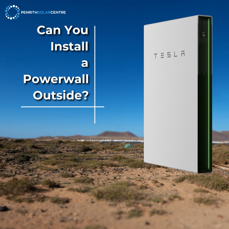Image of a Tesla Powerwall battery in a desert setting with the text "Can You Install a Powerwall Outside?" in white bold letters and a blue sky background.