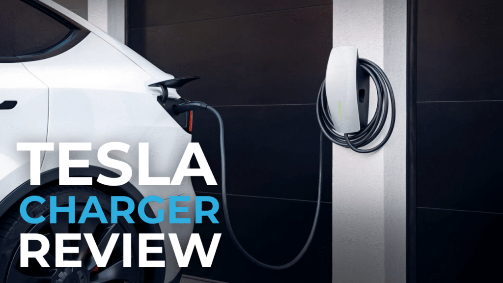 A white Tesla vehicle is plugged into a wall-mounted charger. The words "Tesla Charger Review" are overlaid on the image.