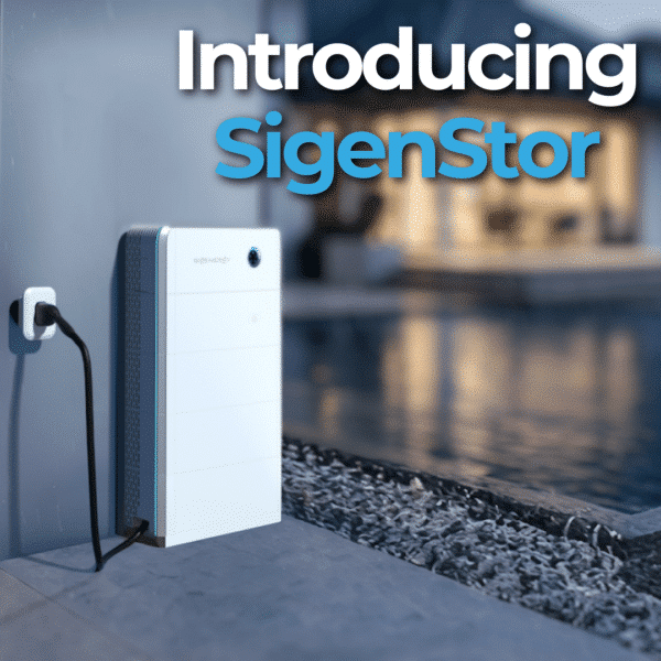 Wall-mounted battery system labeled "SigenStor" connected to an outlet, positioned beside a pool with a modern house in the background.