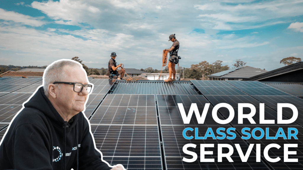 Two workers in safety gear install solar panels on a roof under a cloudy sky. A man in a black hoodie observes. Text reads "World Class Solar Service.