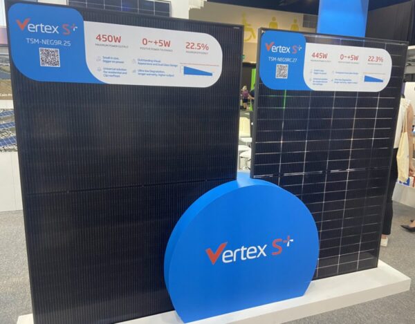 Display of two large Vertex S+ solar panels with specifications: 450W, 445W, and efficiency around 22.5%. Panels are standing vertically with branding visible.